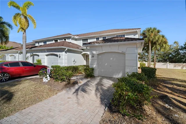 a front view of a house with parking space
