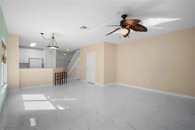 a view of a livingroom with a fireplace furniture and a chandelier