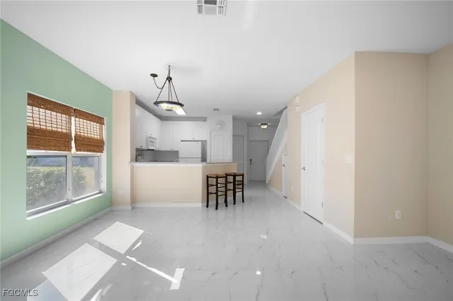 a view of a kitchen with a sink and dishwasher a refrigerator with wooden floor