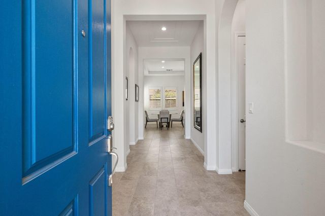 a view of a hallway with furniture and a livingroom