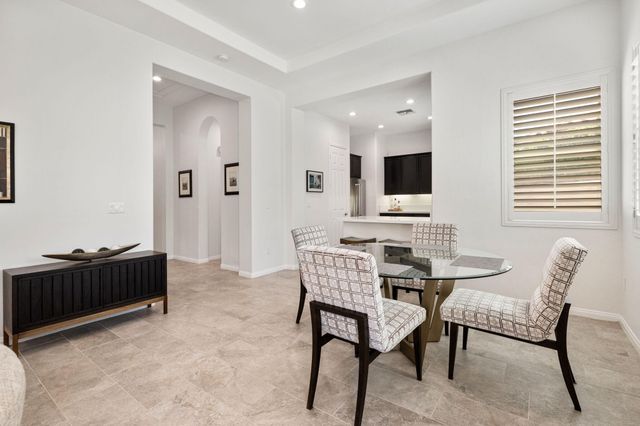 a view of a workspace with furniture and window