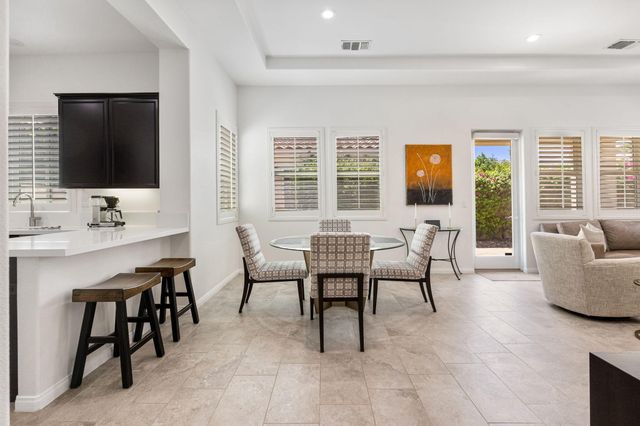 a living room with furniture a flat screen tv and large window