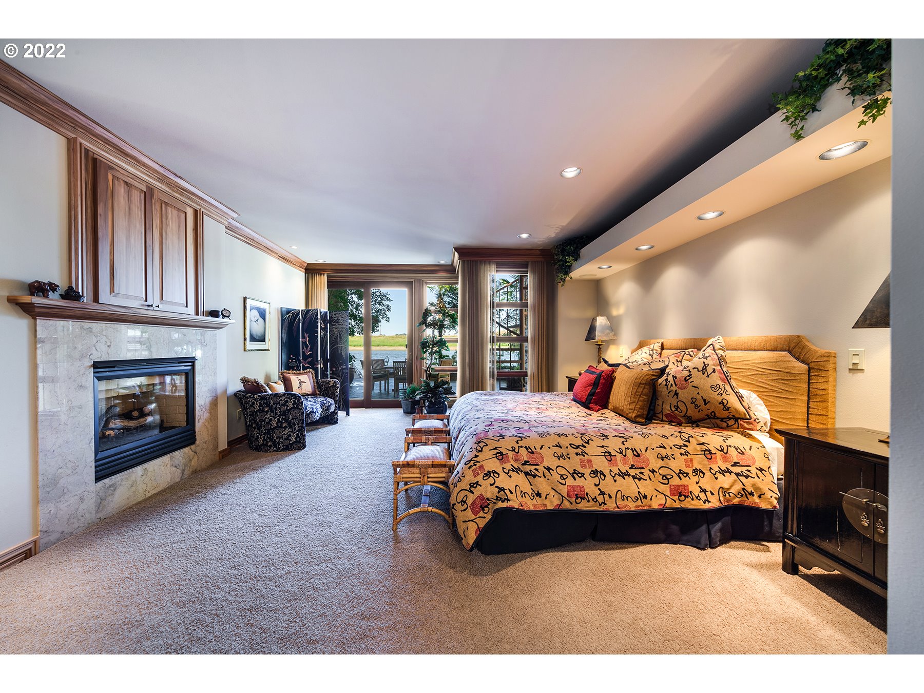 14561 Northwest Larson Road, Unit 16 17 Portland, OR 97231 - Photo 14 of 32 a bedroom with a bed and a fireplace