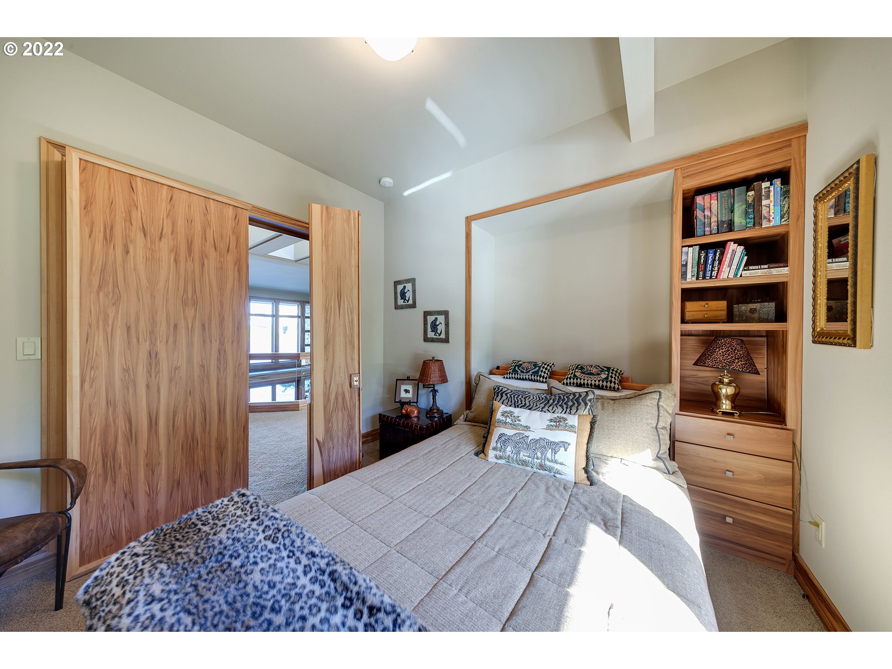 14561 Northwest Larson Road, Unit 16 17 Portland, OR 97231 - Photo 20 of 32 a bedroom with a bed and a book shelf