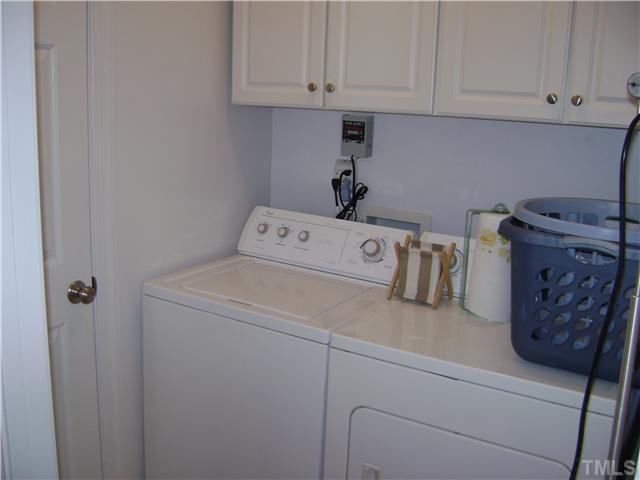 525 Winfred Drive Raleigh, NC 27603 - Photo 11 of 25 Separate 1st floor laundry room with closet and convenient cabinetry for laundry supplies and storage! Laundry Room