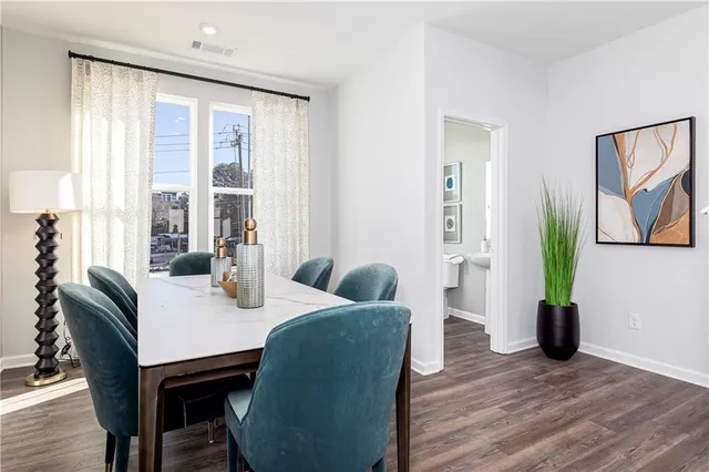 a view of a dining room with furniture window and wooden floor