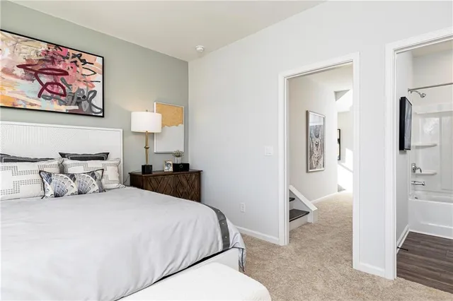 a bedroom with a bed and a view of bathroom