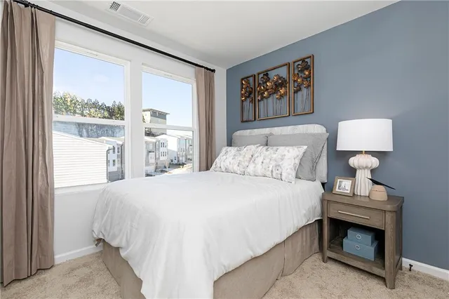 a bedroom with a bed and a night stand