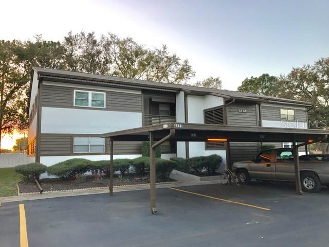 4113 Passport Lane, Unit 101 New Port Richey, FL 34653 - Photo 1 of 1 a view of a car park in front of house