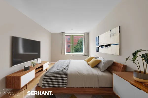a bedroom with a bed and flat screen tv