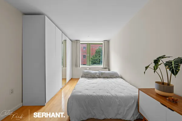 a bedroom with a bed and a window