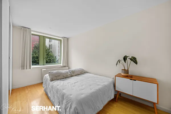 a bedroom with a bed and window