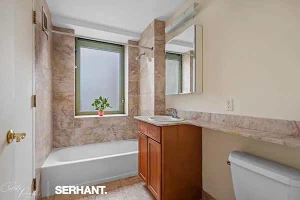 a bath room with a sink and a bath tub