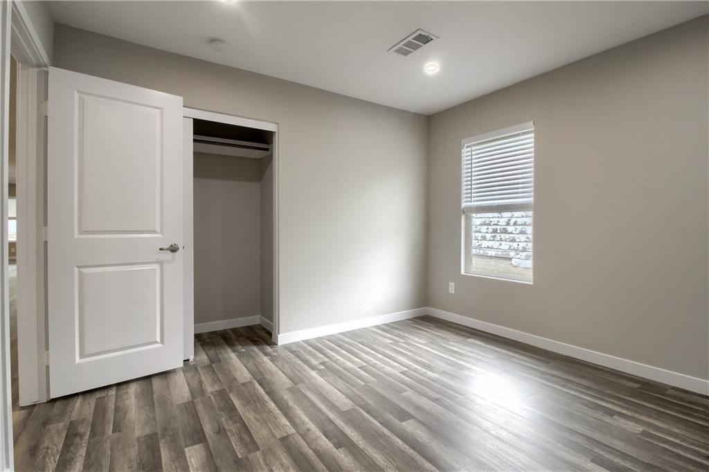 108 Irene Street Elgin, TX 78621 - Photo 14 of 22 wooden floor in an empty room with a window