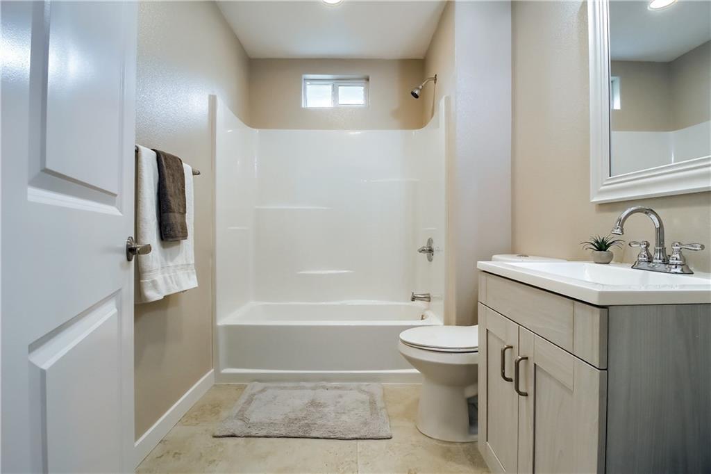 108 Irene Street Elgin, TX 78621 - Photo 17 of 22 a bathroom with a sink a toilet and shower