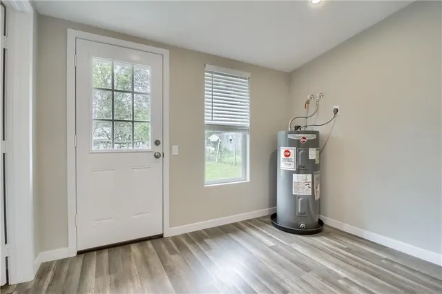 a view of a kitchen with refrigerator and wooden floor