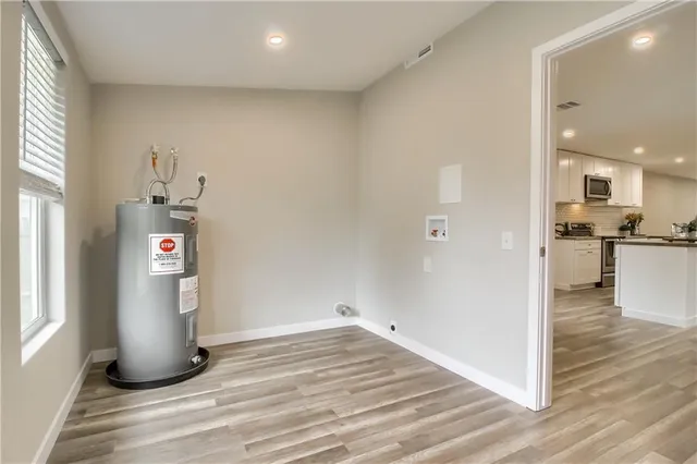 a view of a house with backyard and trees