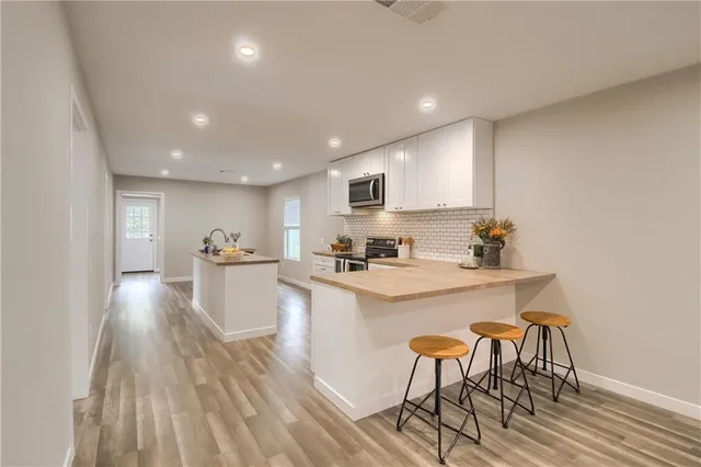 a kitchen with white cabinets and white appliances