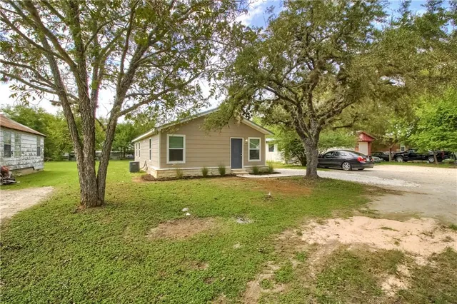 a view of a house with a yard