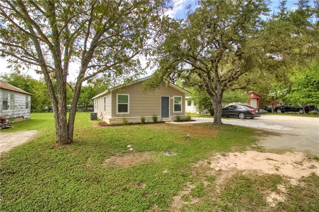108 Irene Street Elgin, TX 78621 - Photo 21 of 22 a view of a yard with a house and a large tree