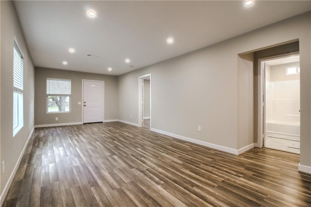 108 Irene Street Elgin, TX 78621 - Photo 5 of 22 a view of empty room with window and wooden floor