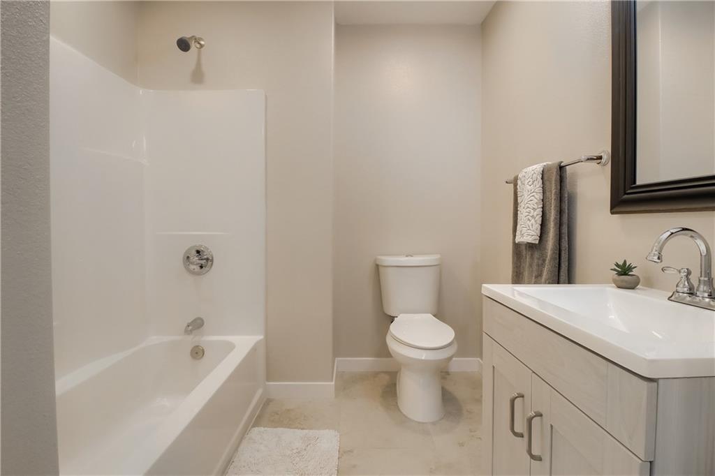 108 Irene Street Elgin, TX 78621 - Photo 10 of 22 a bathroom with a sink toilet and bathtub