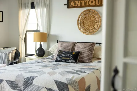 a bed sitting in a bedroom next to a window