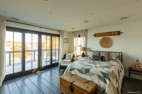 a bedroom with furniture and a wooden floor