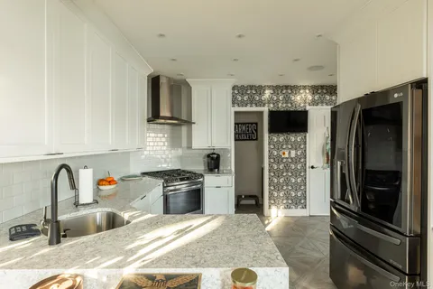 a kitchen with stainless steel appliances granite countertop a refrigerator and a sink