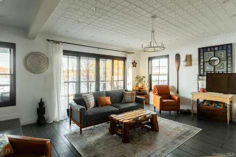 a living room with furniture fireplace and window
