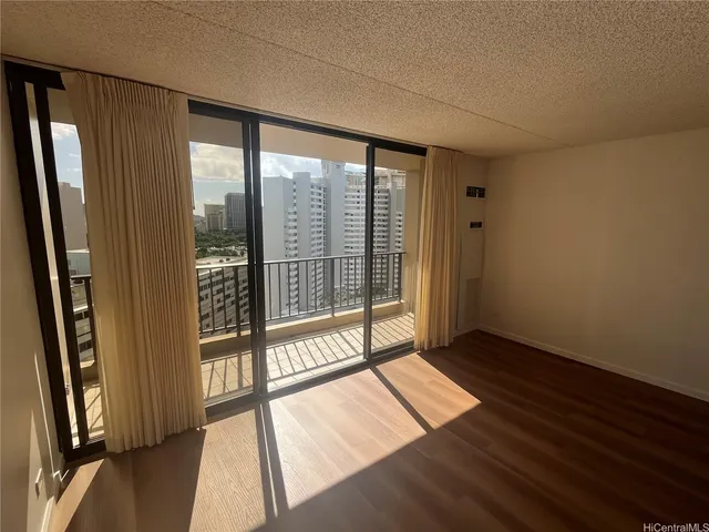 a view of an empty room with glass door