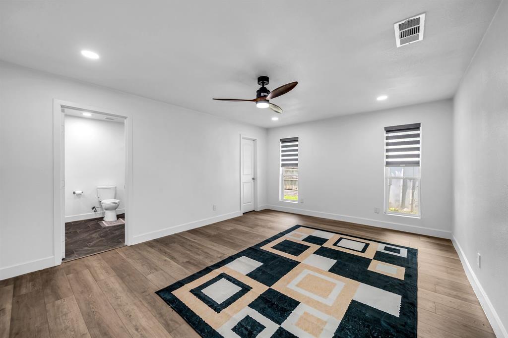 4122 Azalea Lane Garland, TX 75043 - Photo 20 of 26 an empty room with wooden floor and windows