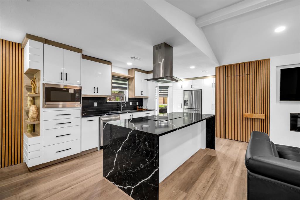 4122 Azalea Lane Garland, TX 75043 - Photo 8 of 26 a kitchen with stainless steel appliances kitchen island granite countertop a stove and a sink