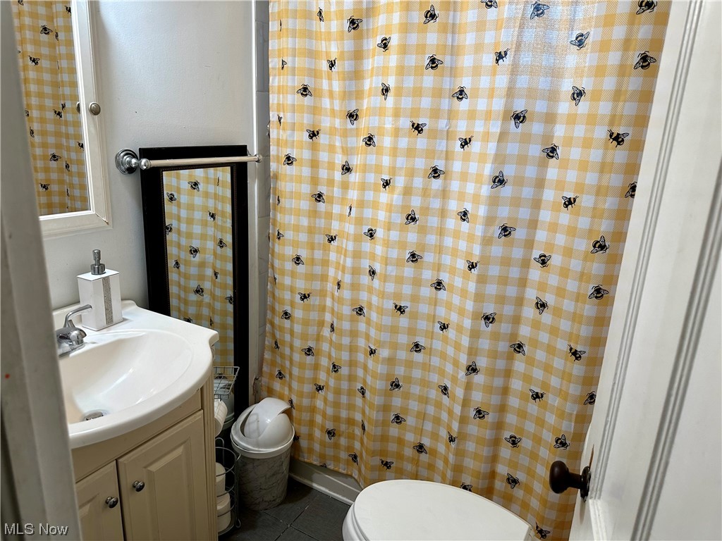 4197 Lambert Road Cleveland, OH 44121 - Photo 7 of 13 Bathroom with toilet, tile floors, and vanity with extensive cabinet space