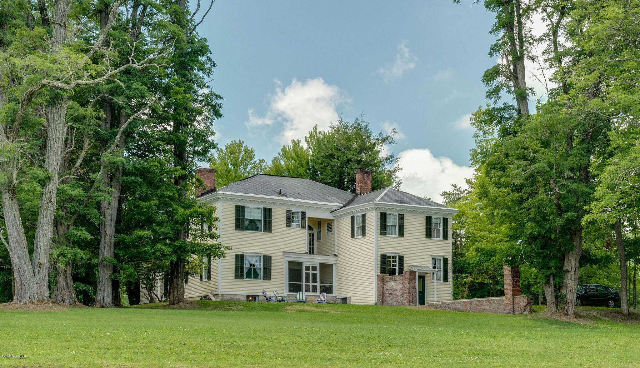 1385 State Road Richmond, MA 01254 - Photo 2 of 25 a front view of a house with a garden