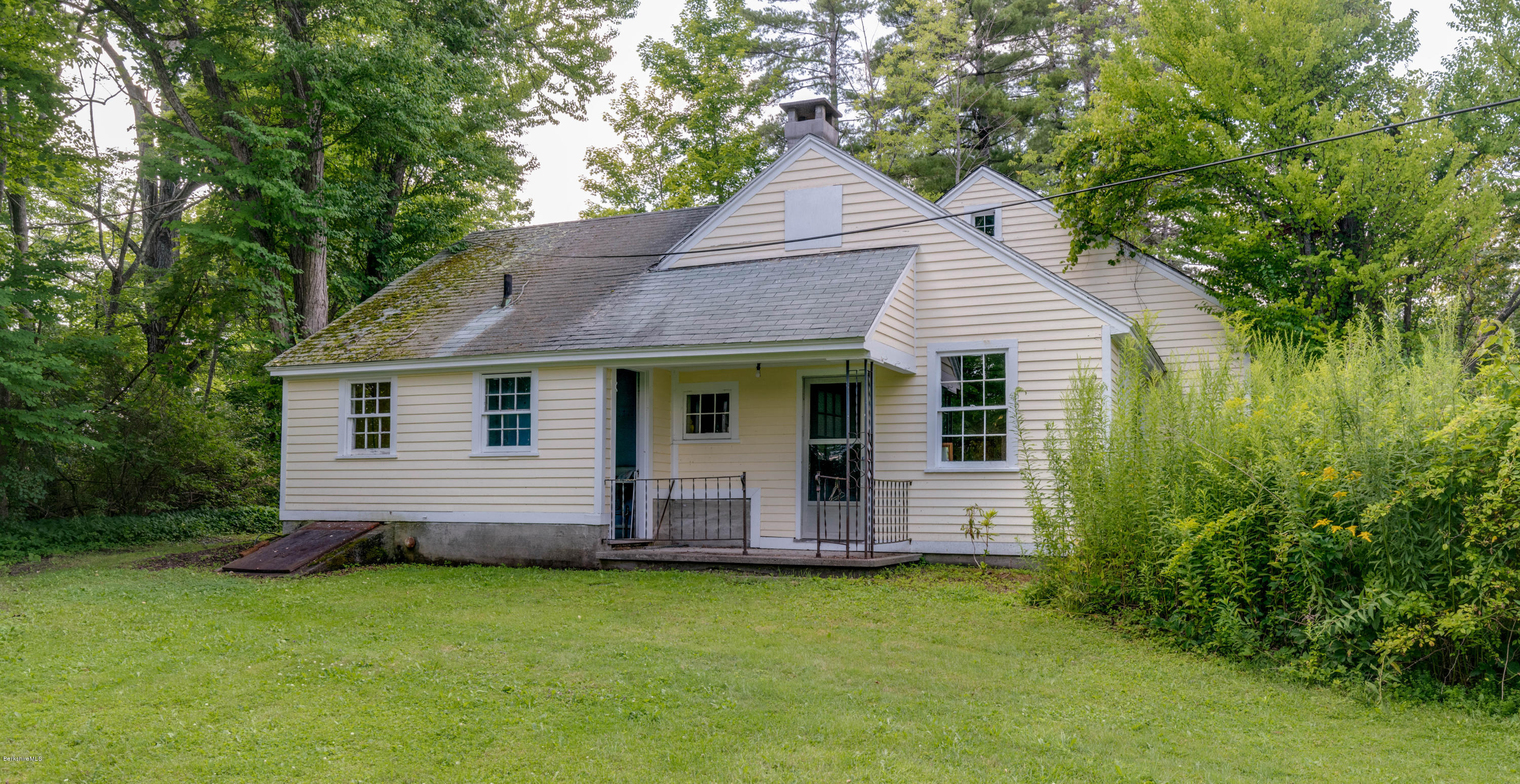 1385 State Road Richmond, MA 01254 - Photo 21 of 25 a front view of a house with a garden