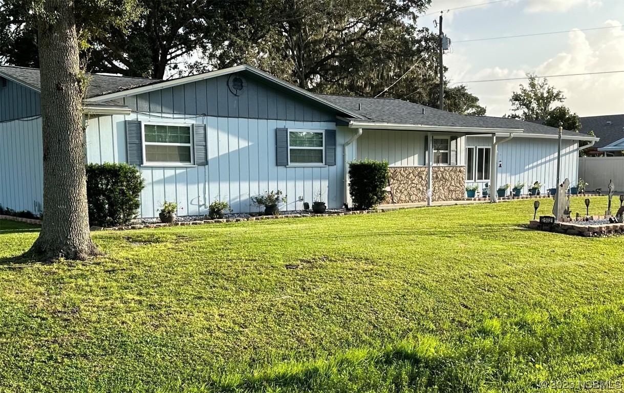 2502 Umbrella Tree Drive Edgewater, FL 32141 - Photo 1 of 26 a view of a house with a yard patio and fire pit