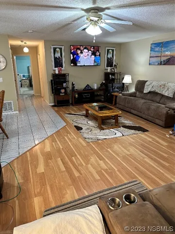 a living room with furniture gym equipment and a flat screen tv