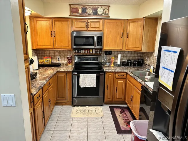 a kitchen with stainless steel appliances a stove sink and microwave