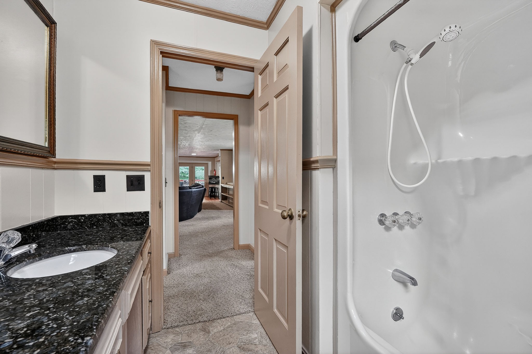 5642 Pates Ford Road Smithville, TN 37166 - Photo 16 of 32 a bathroom with a granite countertop shower a mirror and a sink
