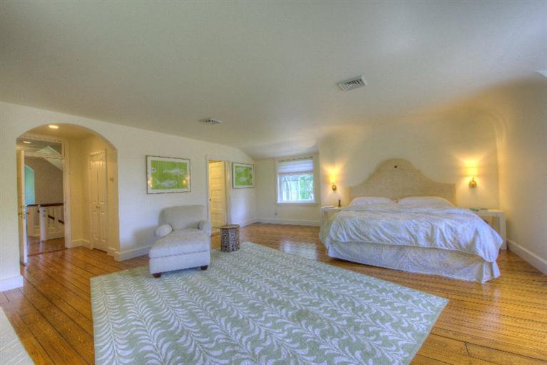 150 Sea View Avenue Osterville, MA 02655 - Photo 11 of 26 a spacious bedroom with a bed and wooden floor