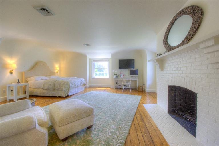 150 Sea View Avenue Osterville, MA 02655 - Photo 12 of 26 a bedroom with furniture and a fireplace