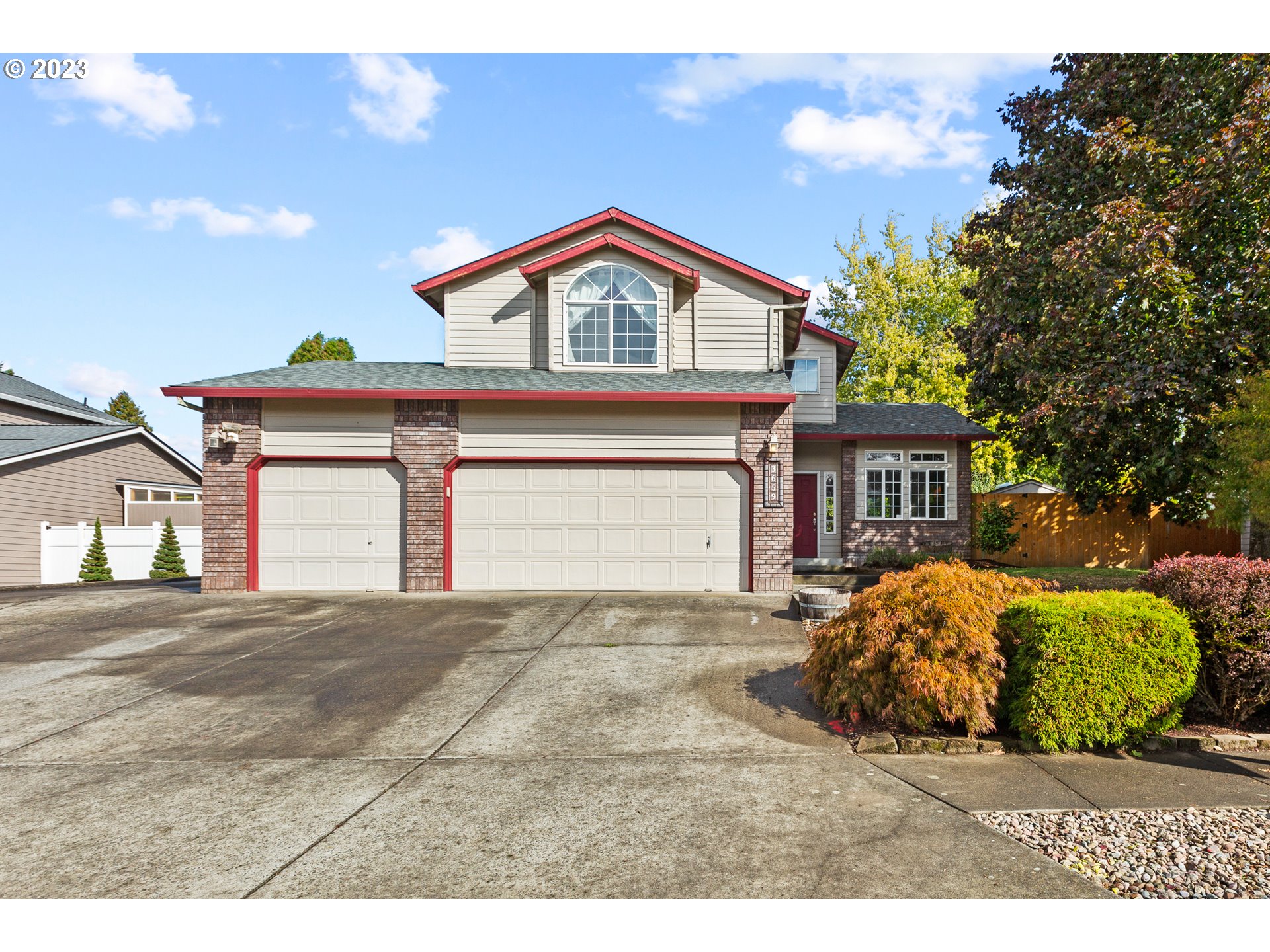 a view of a house with a yard and garage