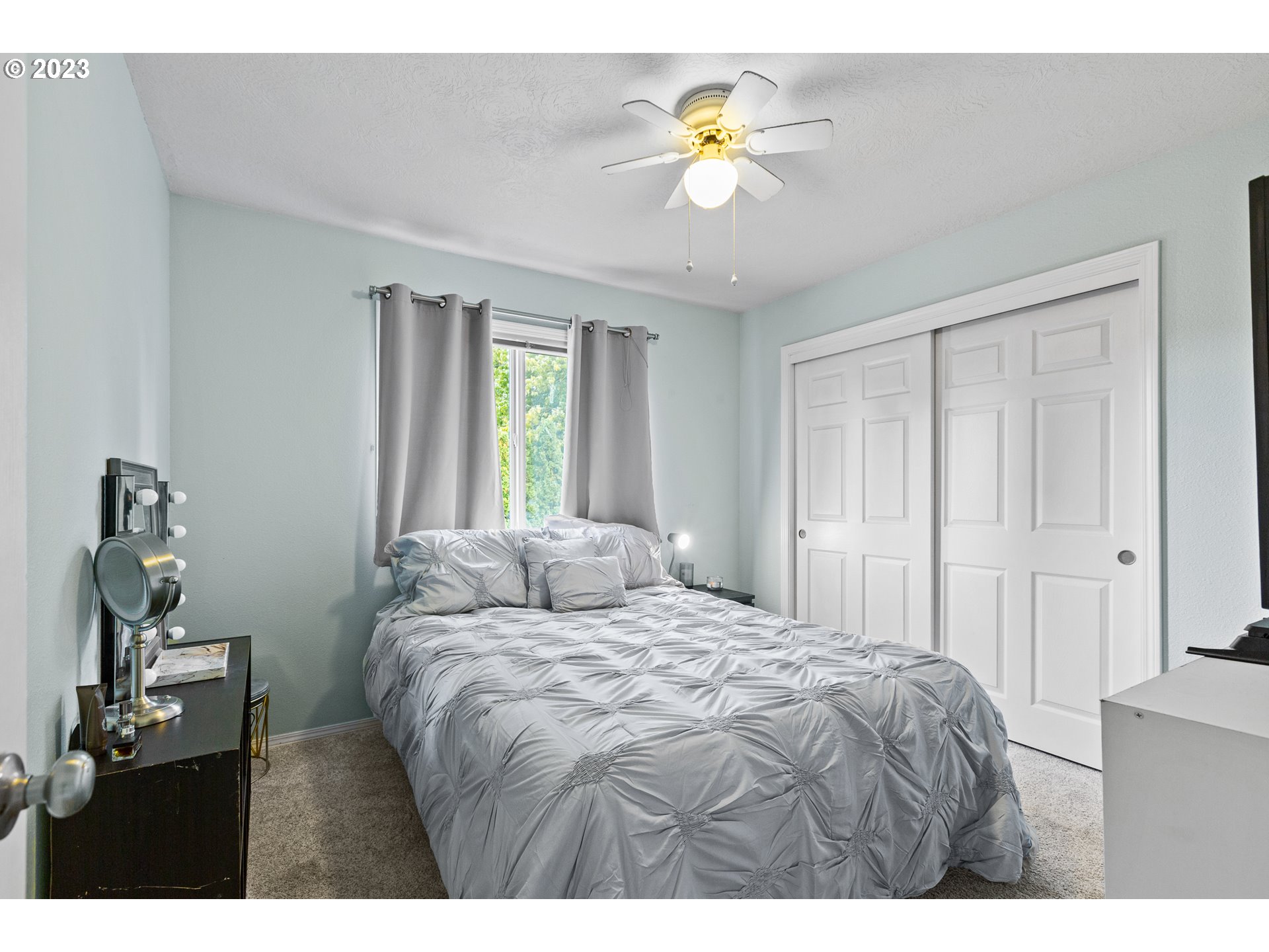 3659 Southeast 10th Street Gresham, OR 97080 - Photo 17 of 34 a bedroom with a bed and a chandelier