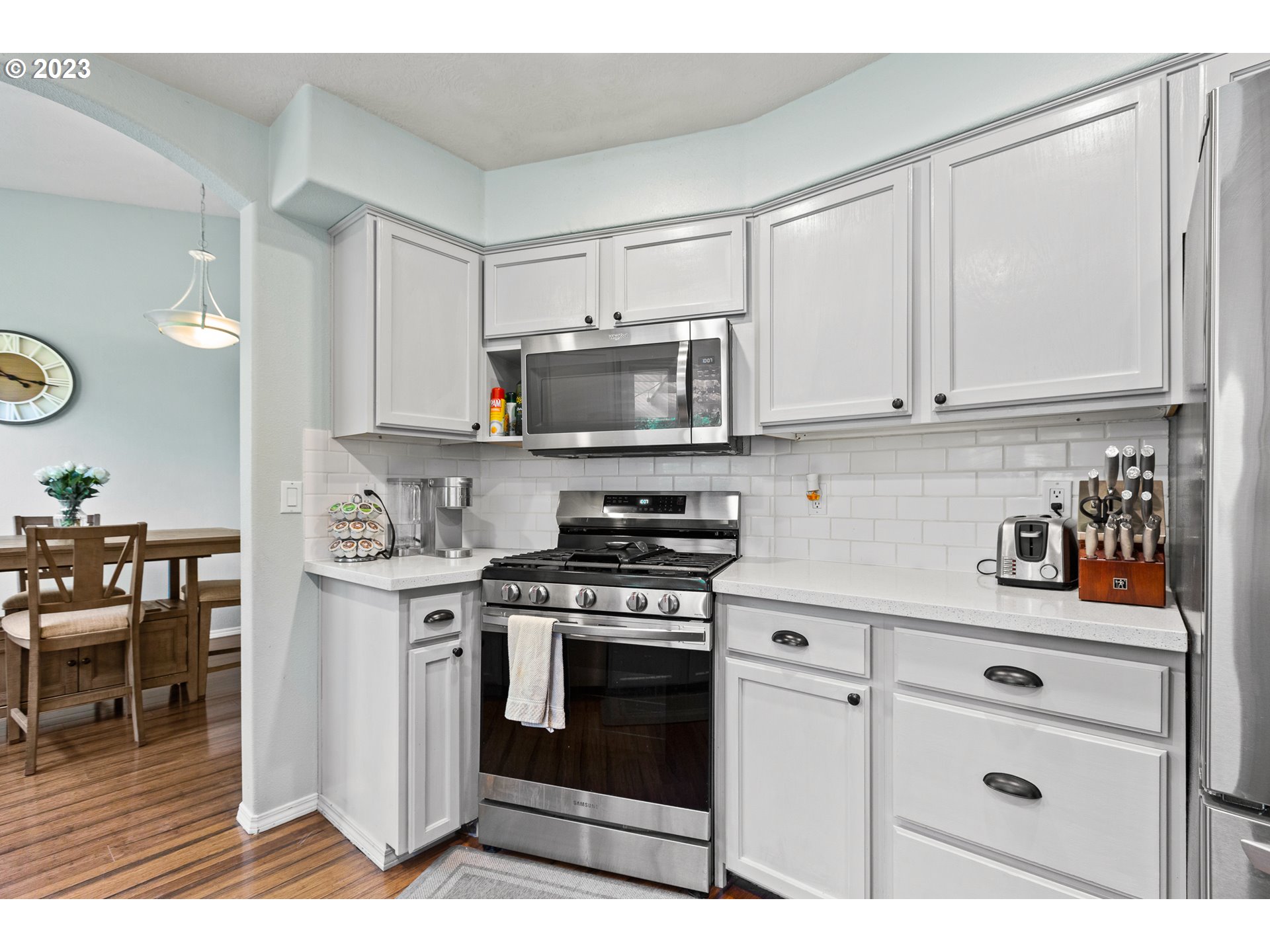 3659 Southeast 10th Street Gresham, OR 97080 - Photo 6 of 34 a kitchen with stainless steel appliances granite countertop a stove a sink and a microwave