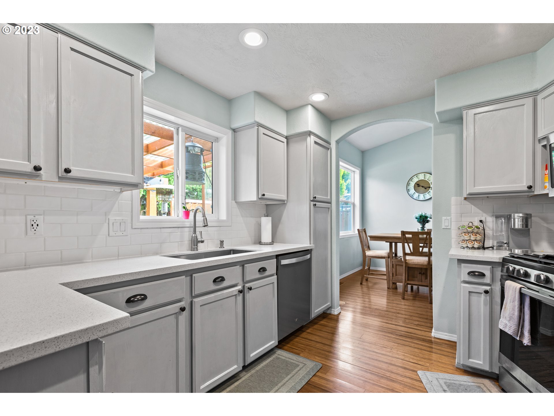 3659 Southeast 10th Street Gresham, OR 97080 - Photo 7 of 34 a kitchen with stainless steel appliances granite countertop a sink window and cabinets