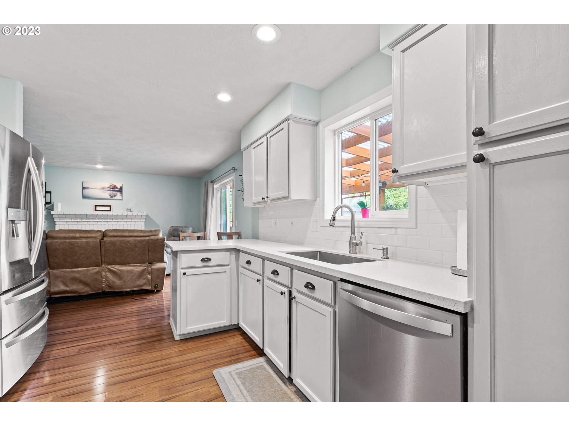 3659 Southeast 10th Street Gresham, OR 97080 - Photo 8 of 34 a kitchen with a sink cabinets stainless steel appliances and windows