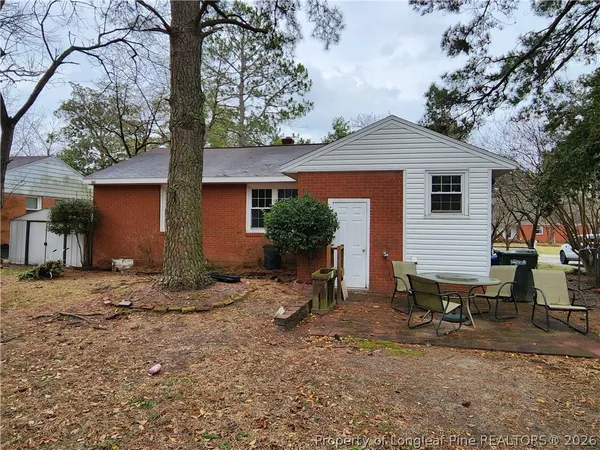 a backyard of a house with table and chairs