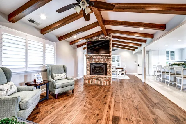 a kitchen with a dining table chairs sink and stove