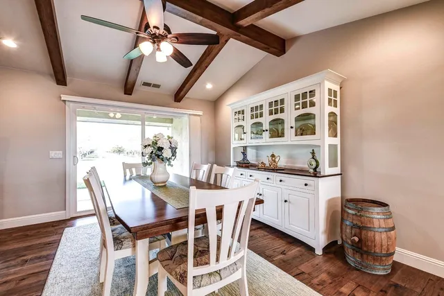 a kitchen with stainless steel appliances kitchen island granite countertop a sink cabinets and wooden floor